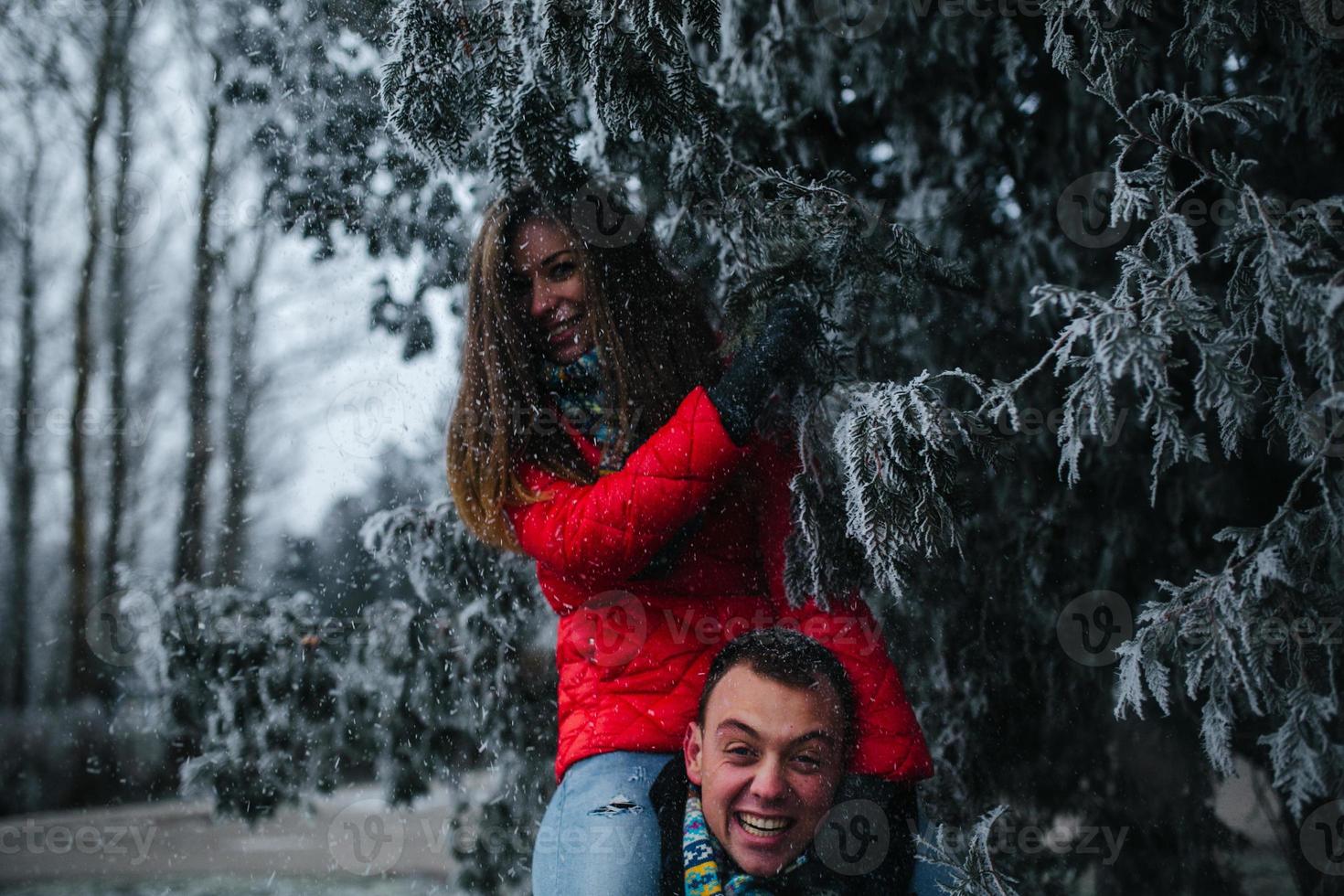 man carries his girlfriend on back photo