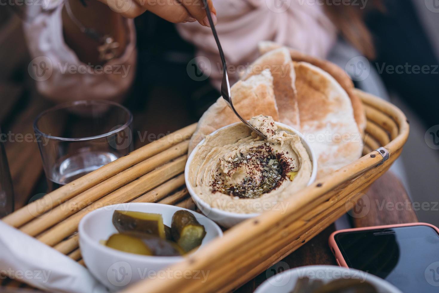 Fresh delicious hummus, pita bread and pickles cucumbers photo