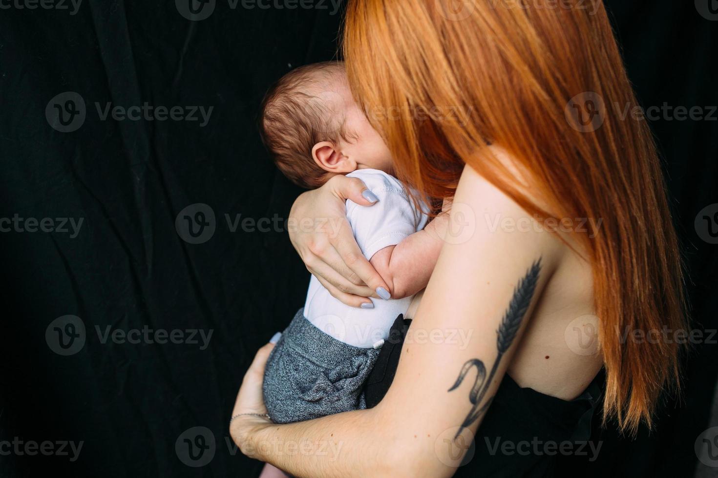 Young mother woman holding her child baby photo