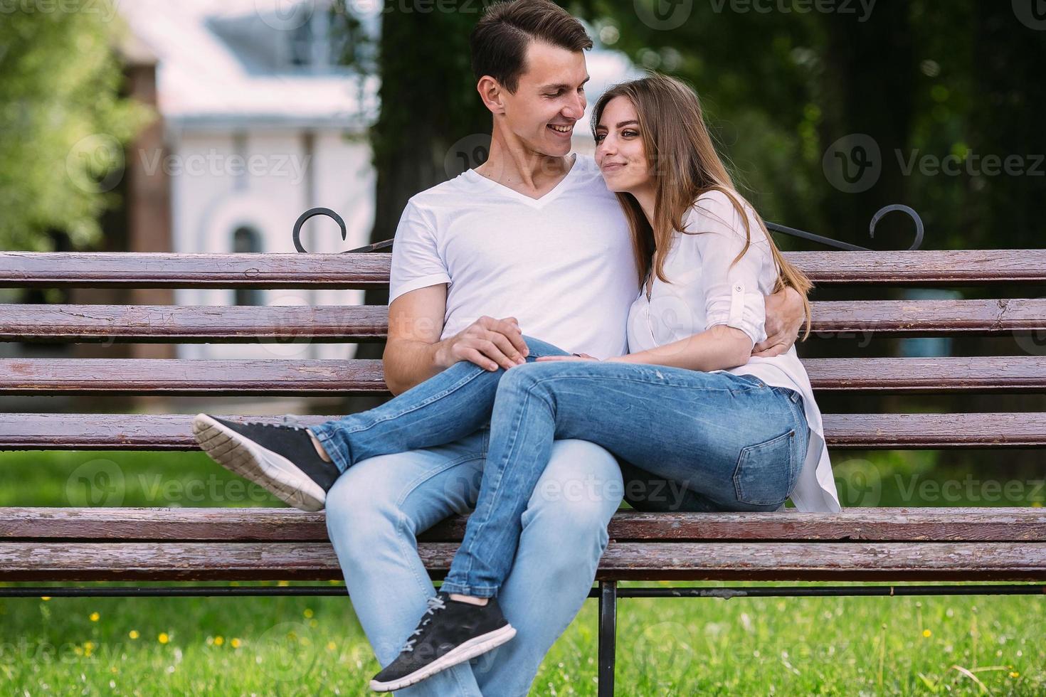 man and woman on a bench in the park photo
