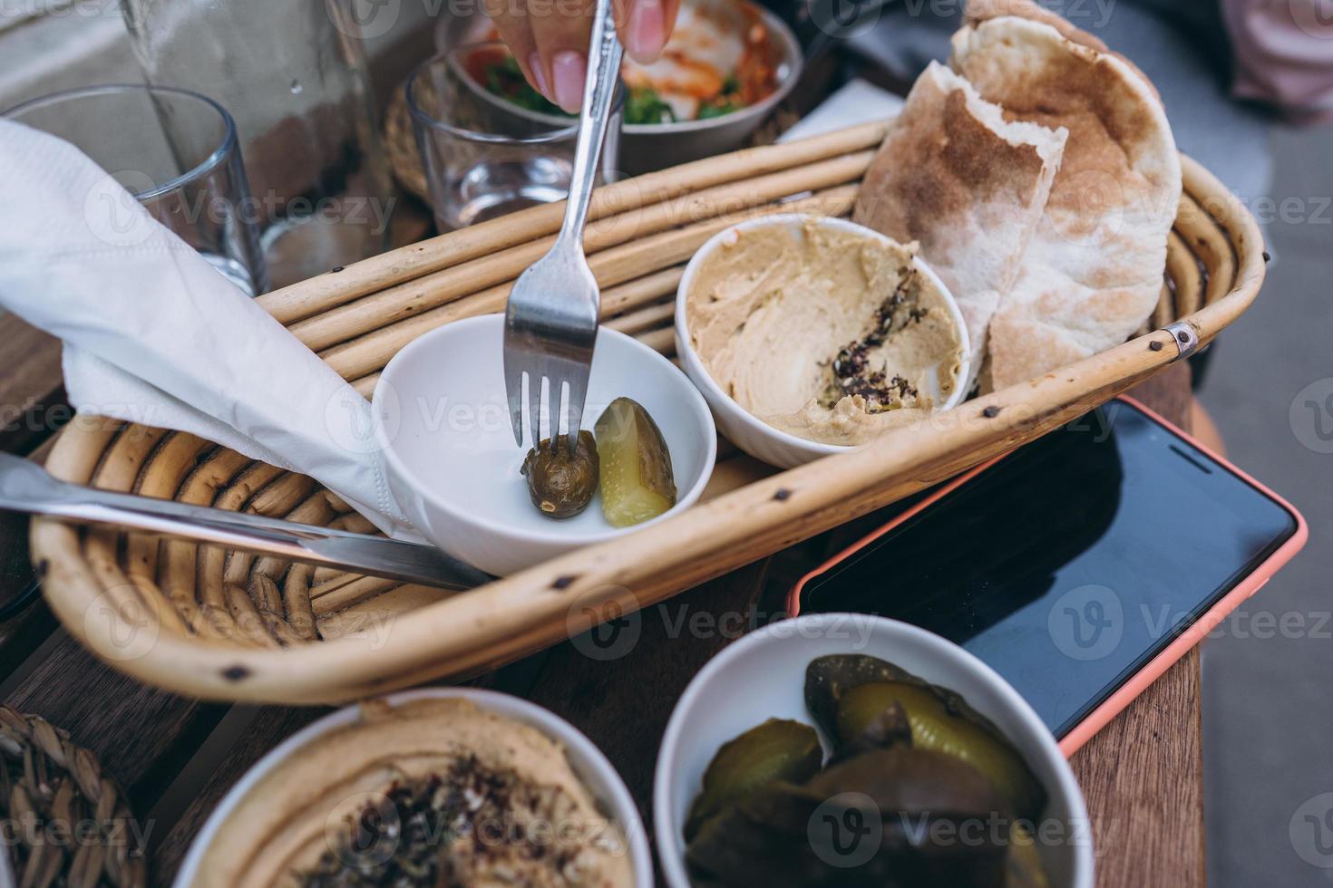 Fresh delicious hummus, pita bread and pickles cucumbers photo