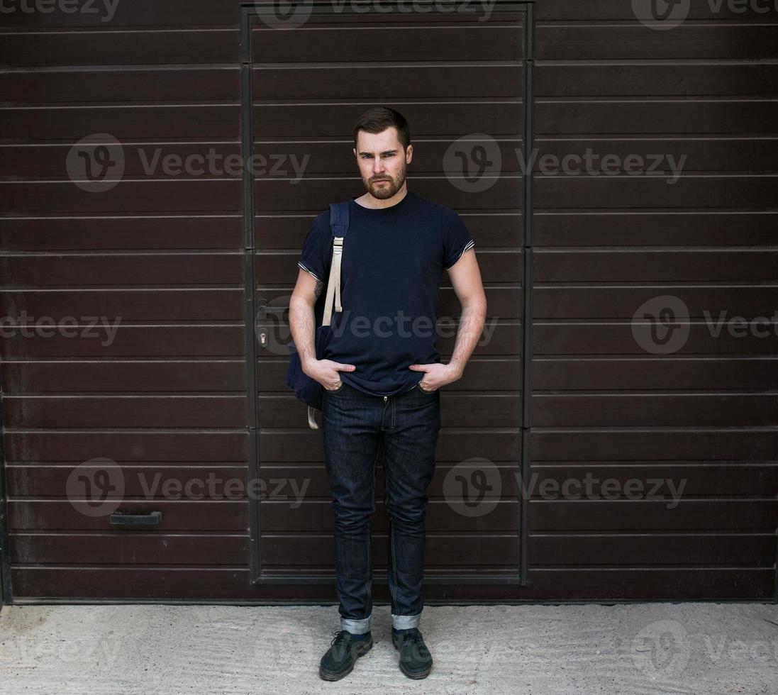 The man in the authentic boots and selvedge jeans  on a background of old city photo