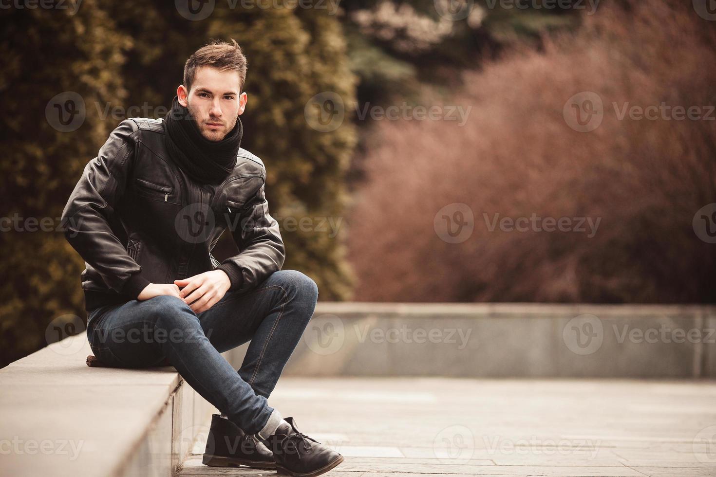 Fashion male model on the bench photo