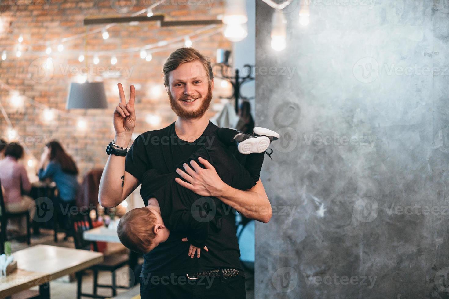 Dad is holding his little son in his arms photo