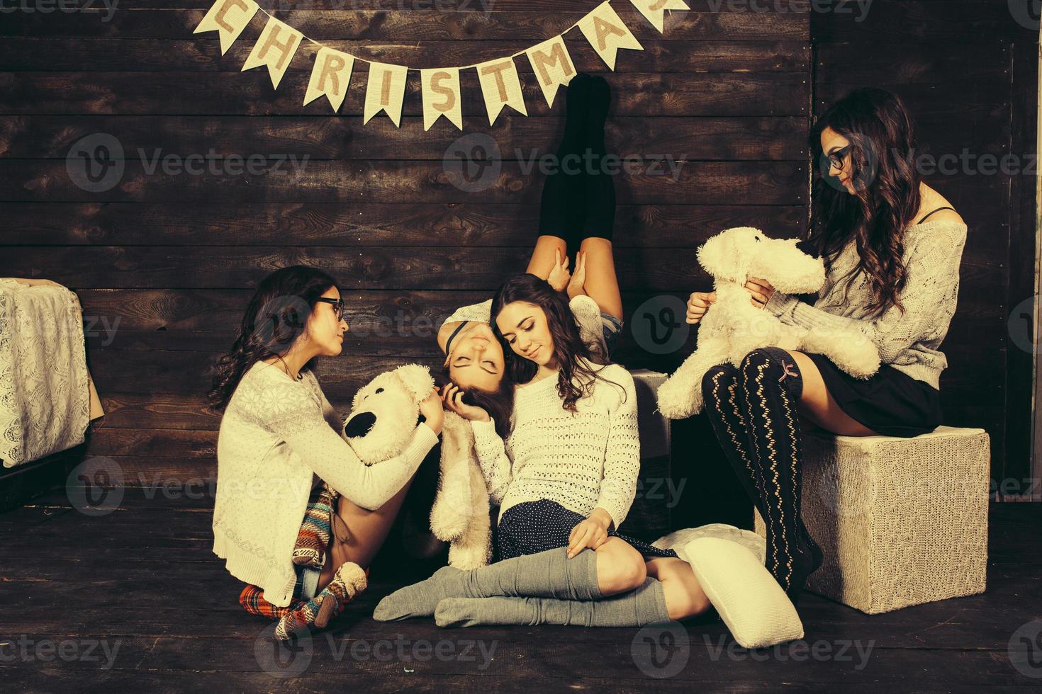 Four charming model posing on a vintage New Year's background photo