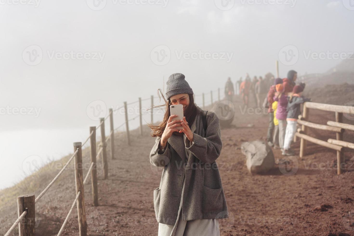 Girl climbs the path to the mountain photo