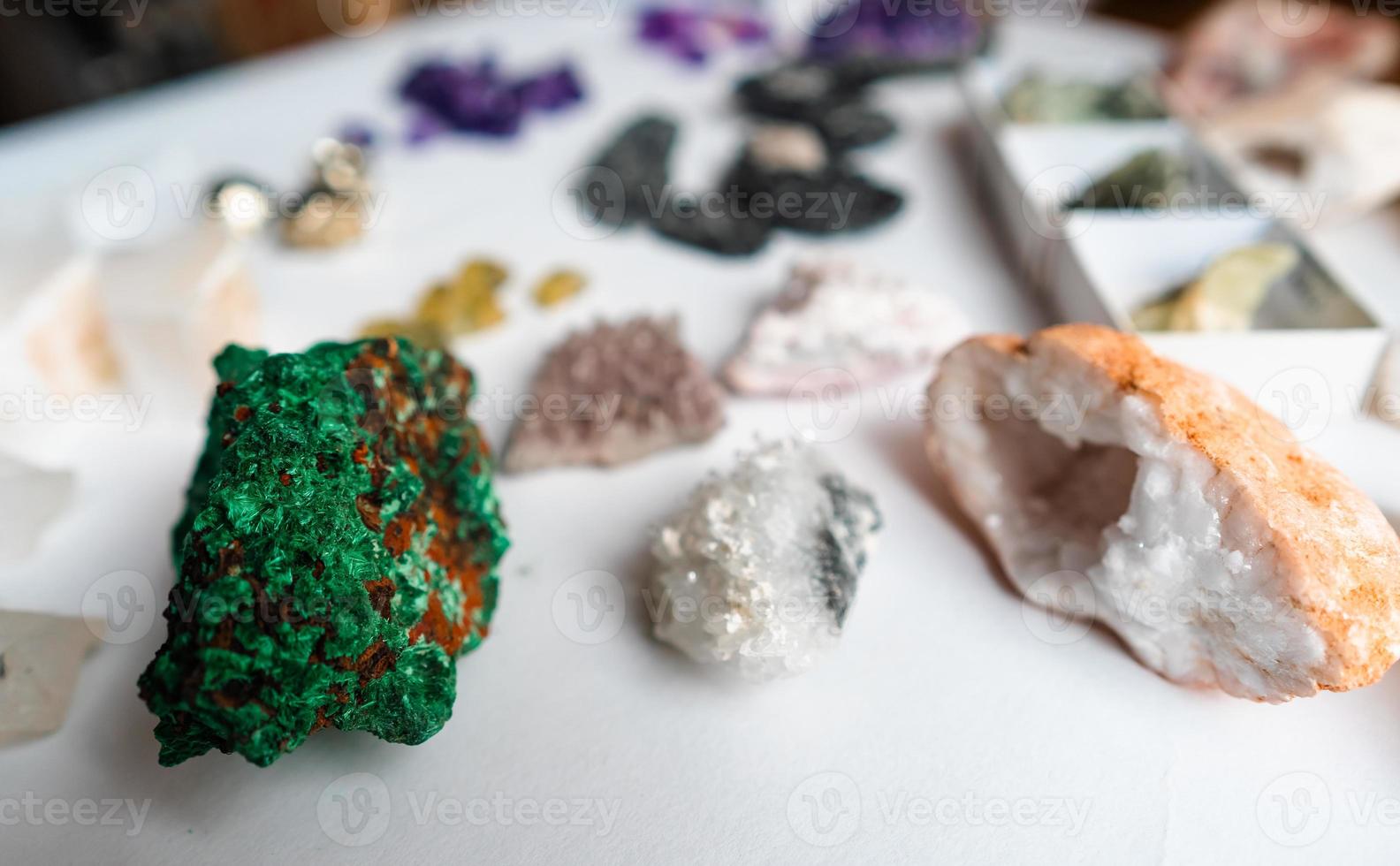 Collection of beautiful precious stones on white table. photo