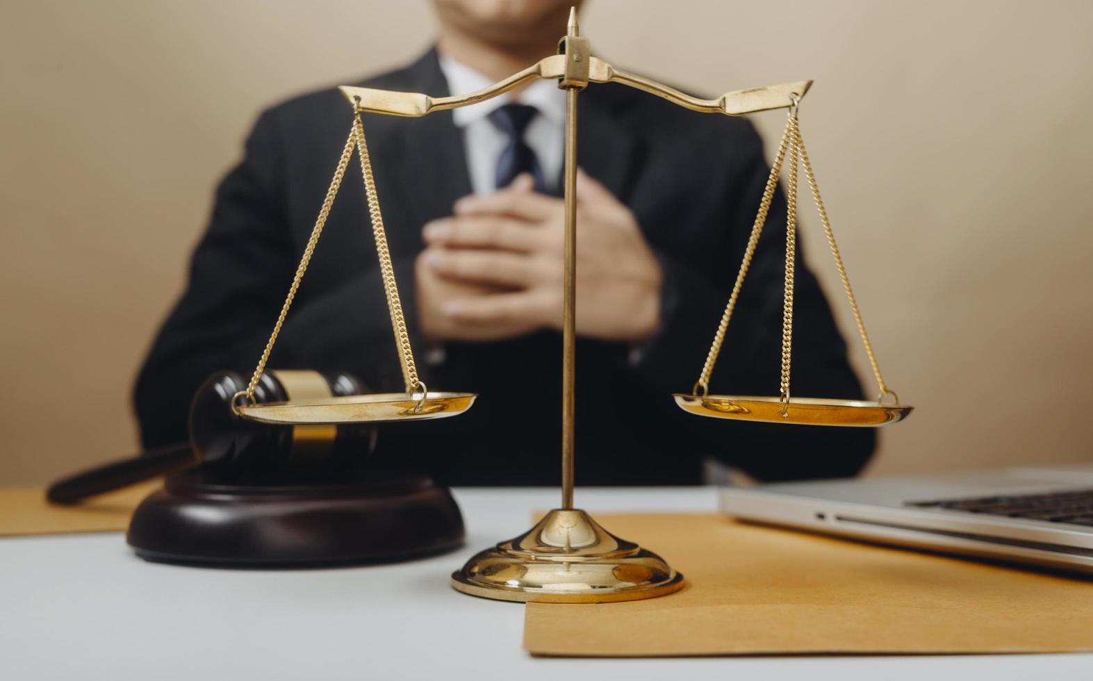 Business and lawyers discussing contract papers with brass scale on desk in office. Law, legal services, advice, justice and law concept picture with film grain effect photo