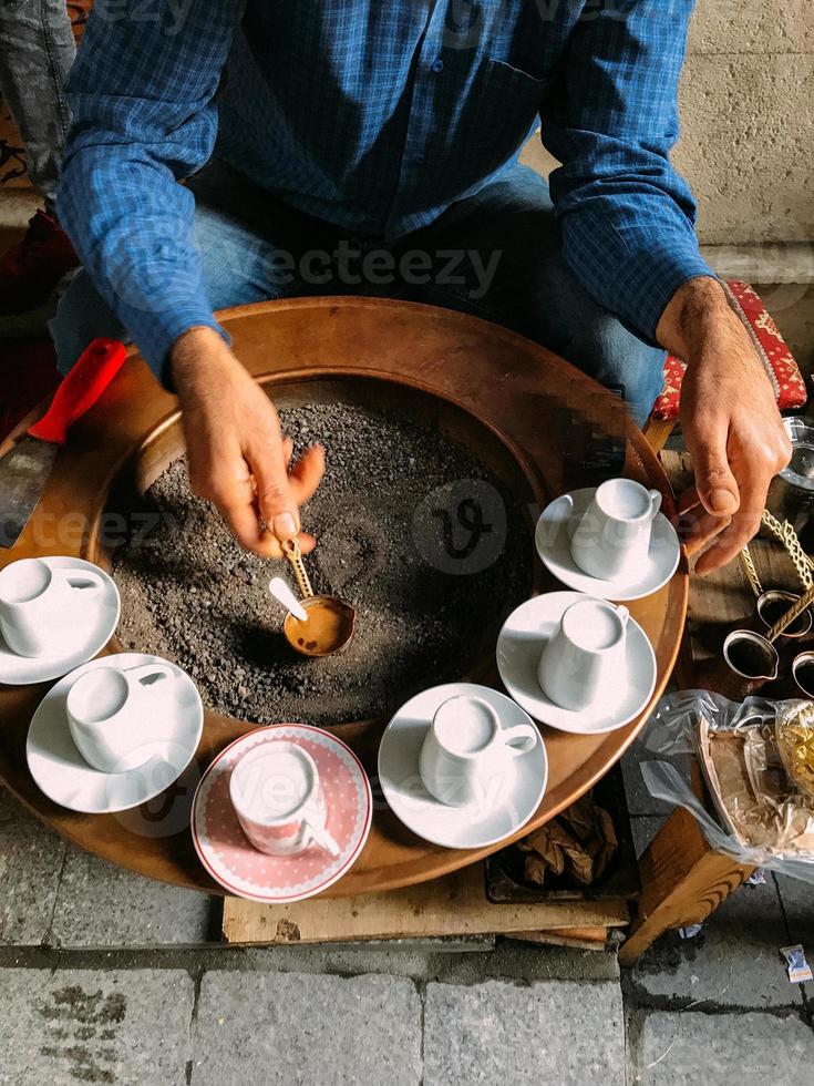 A man make Turkish coffee photo