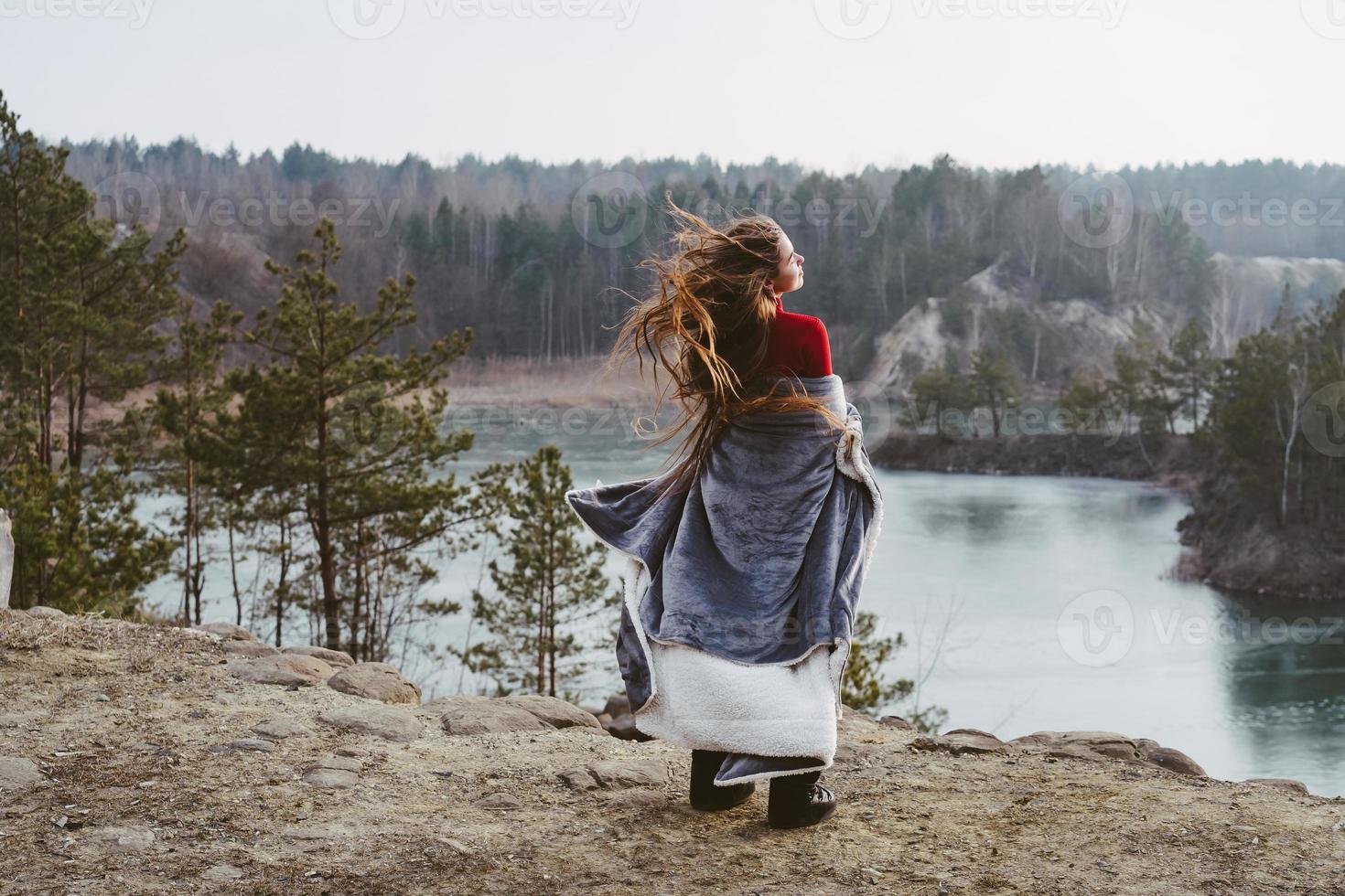 Young beautiful girl posing on a background of lake photo