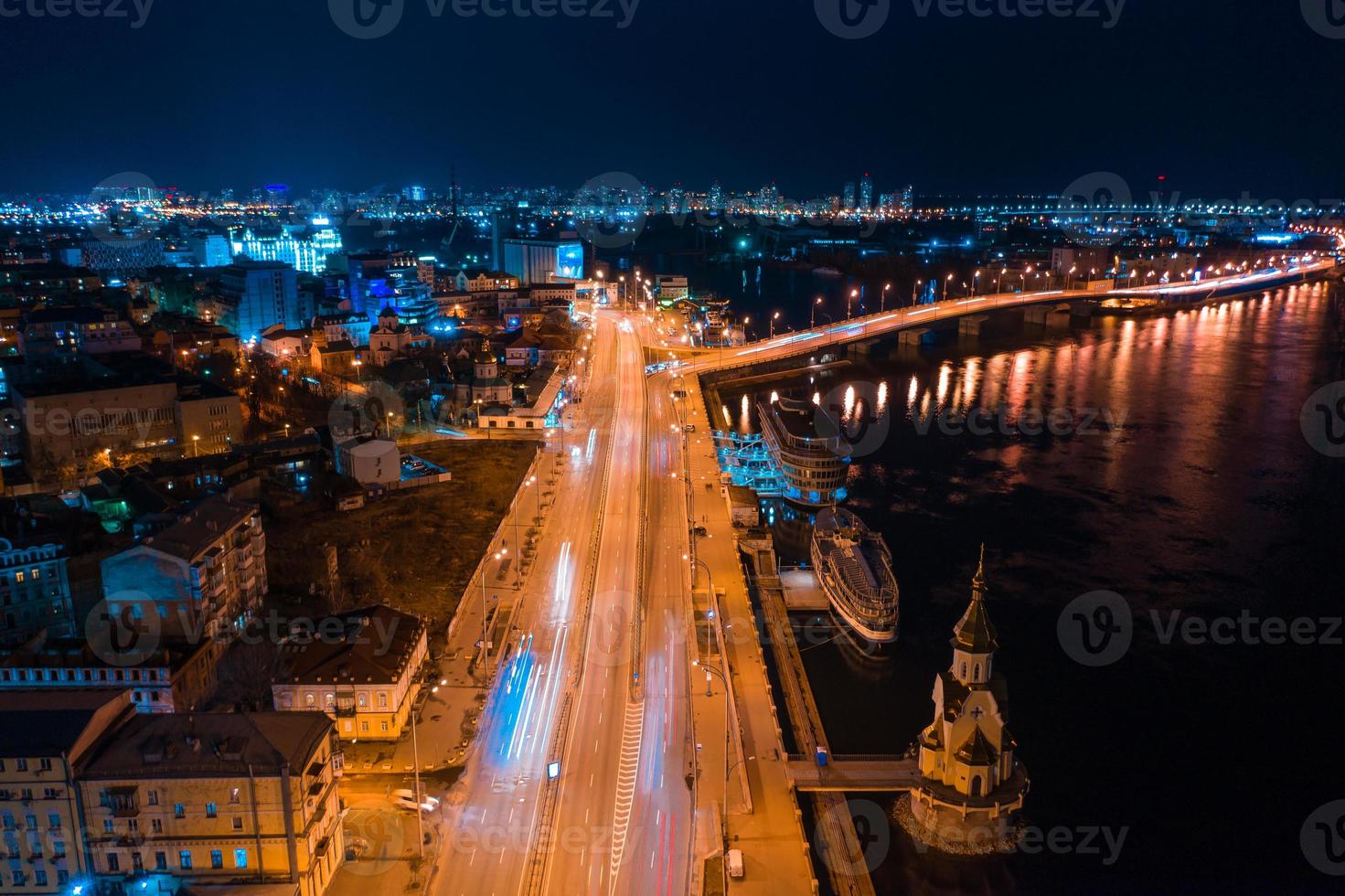 Highway at night in modern city. Aerial view of cityscape photo