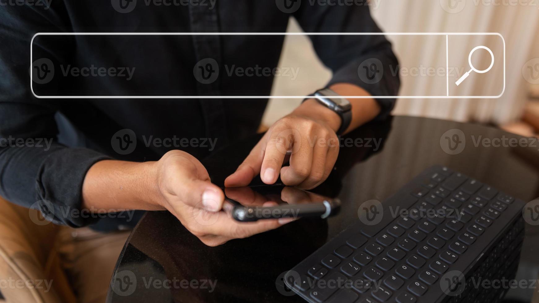 Searching Browsing Internet Data Information Networking Concept with blank search bar.man working with mobile phone and laptop computer VR icon in office photo