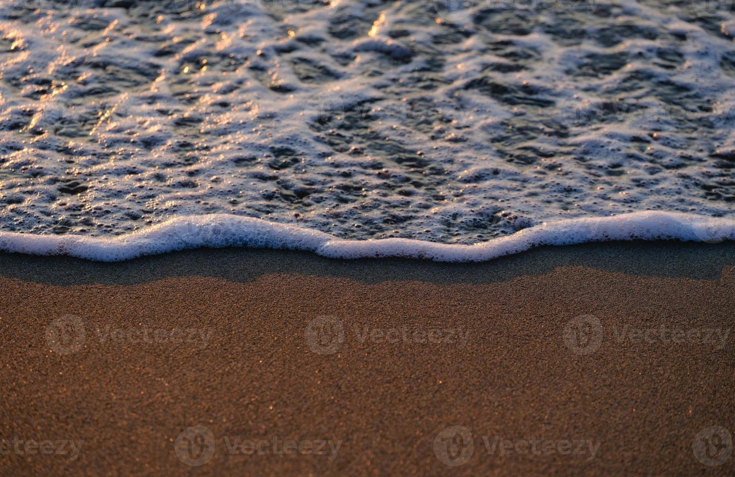 Sandy beach and sea waves photo