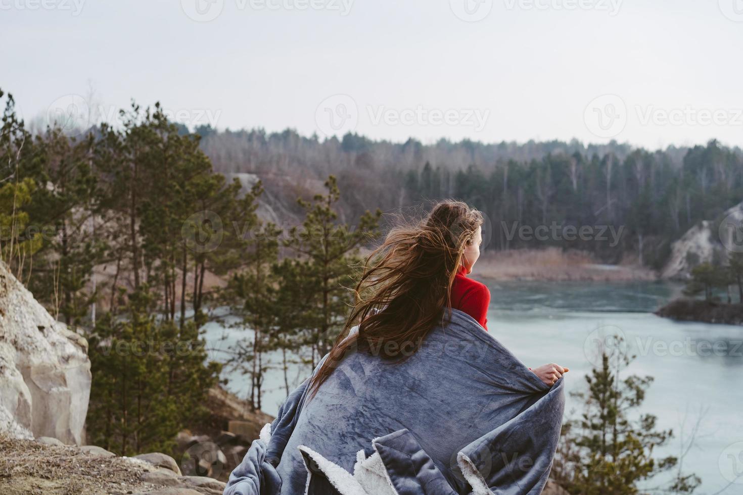 Young beautiful girl posing on a background of lake photo