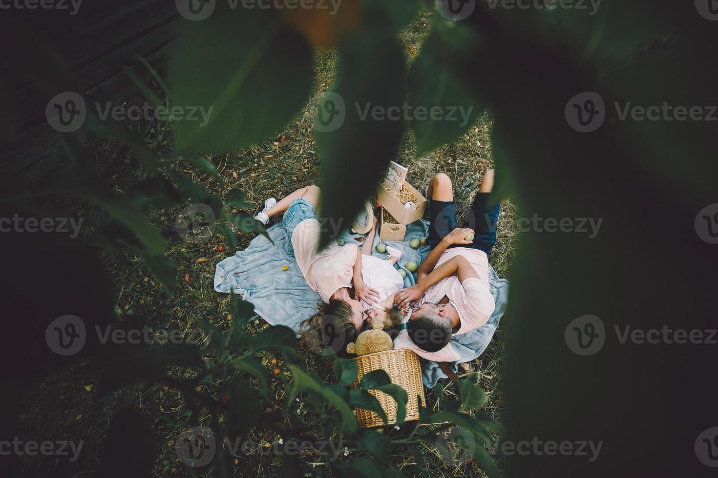 Happy family on lawn in the park photo