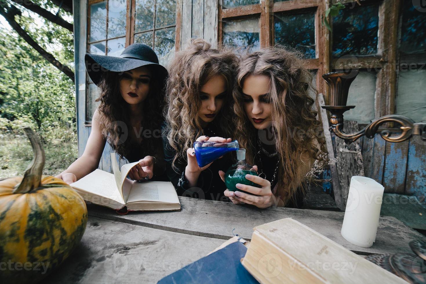 Three vintage witches perform magic ritual photo