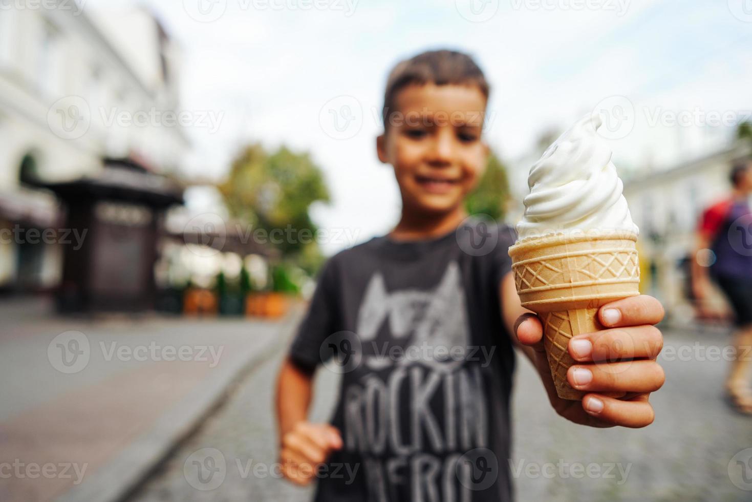 happy child eating ice cream on a summer day photo