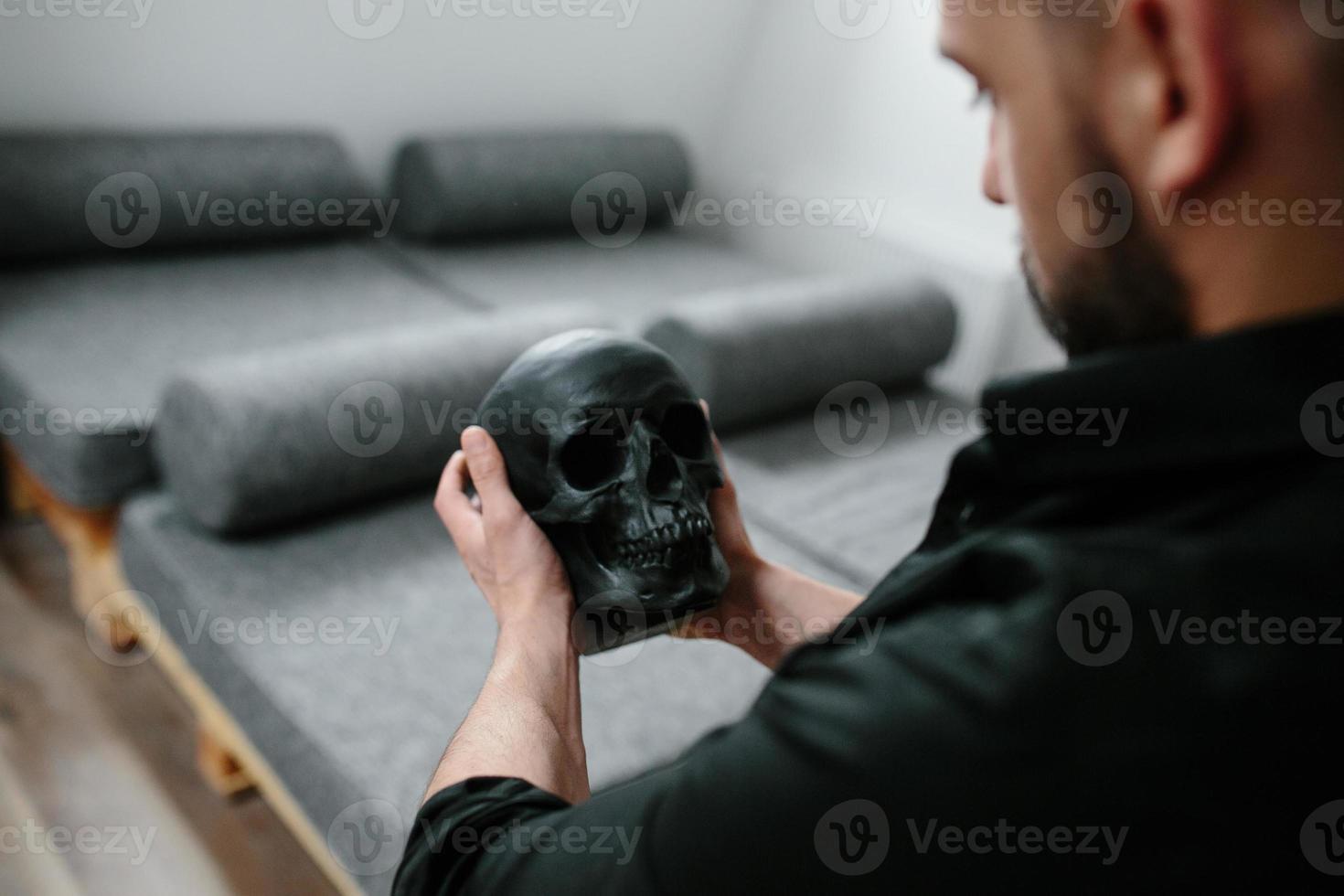 bearded man holding skull photo