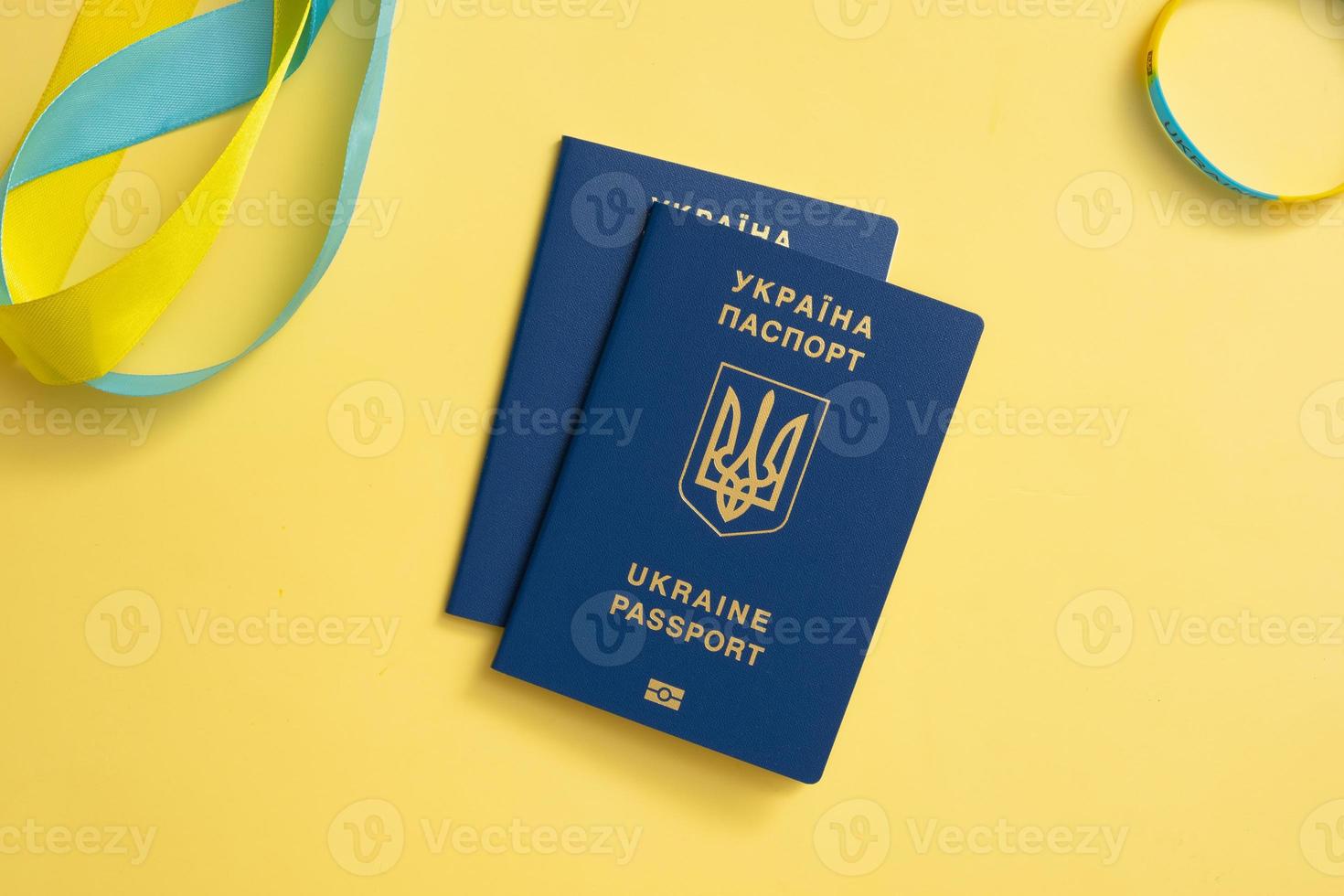 Passports of a citizen of Ukraine on a yellow background top view, close-up. Inscription in Ukrainian Ukraine Passport photo