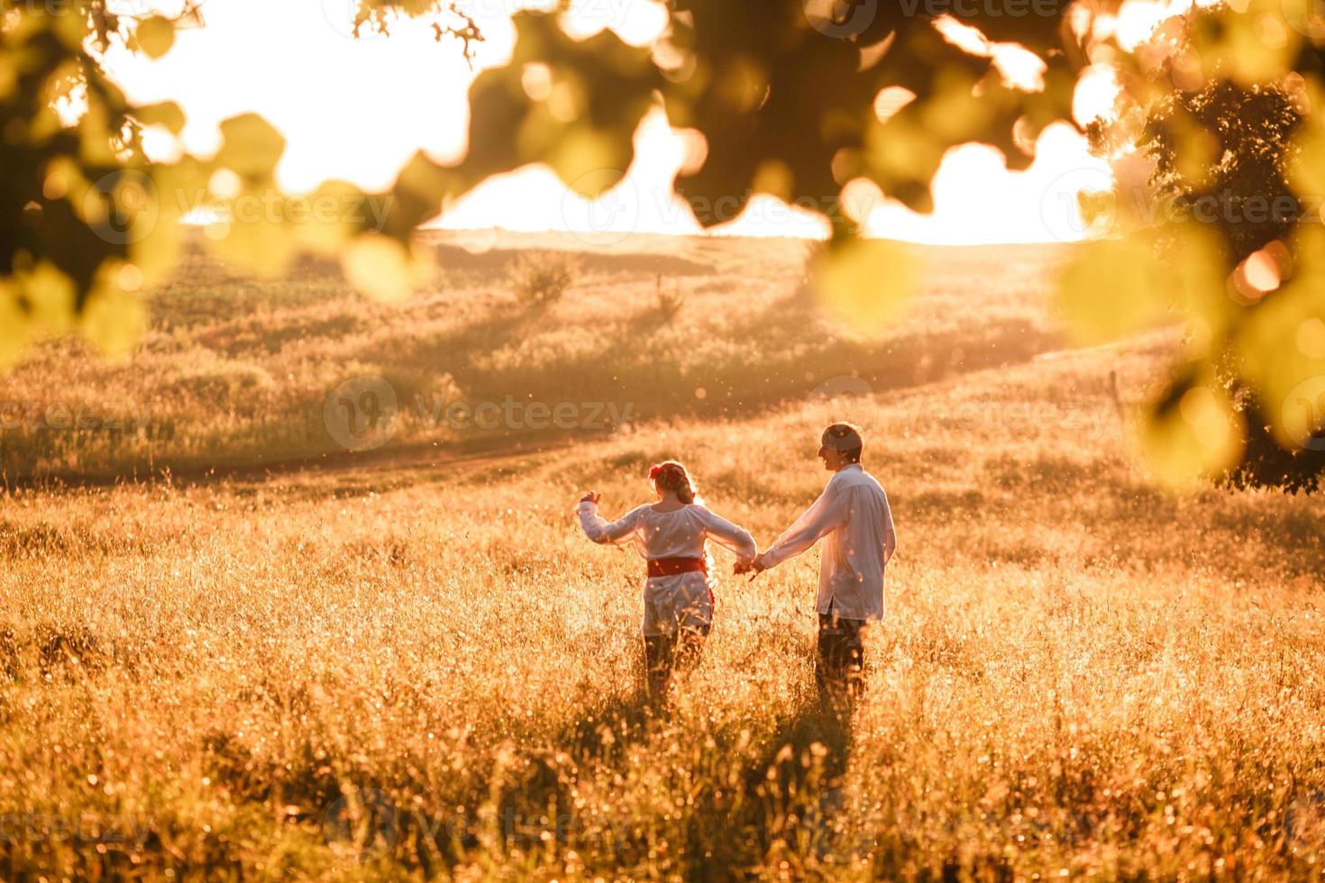 Couple running to the sunset photo