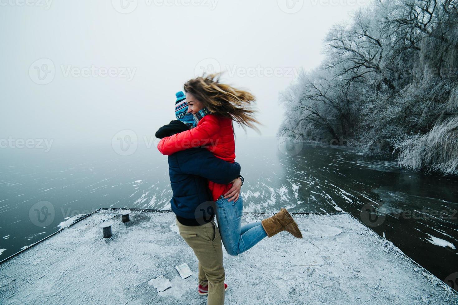 beautiful couple having fun on the pier photo