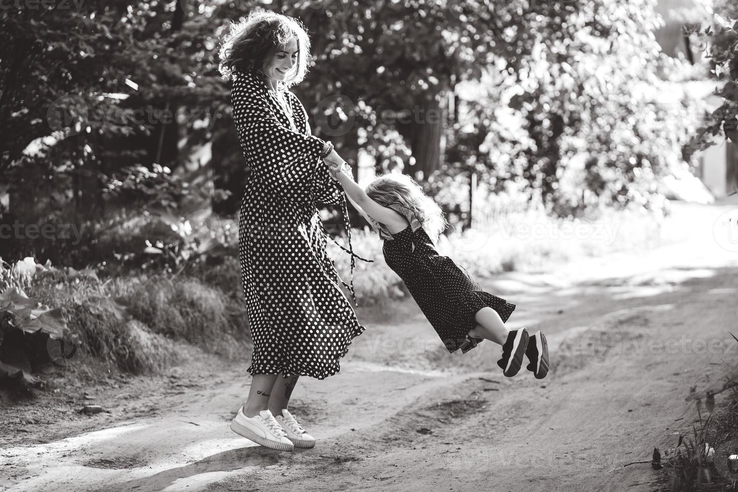 Mom and little daughter are having fun and playing photo