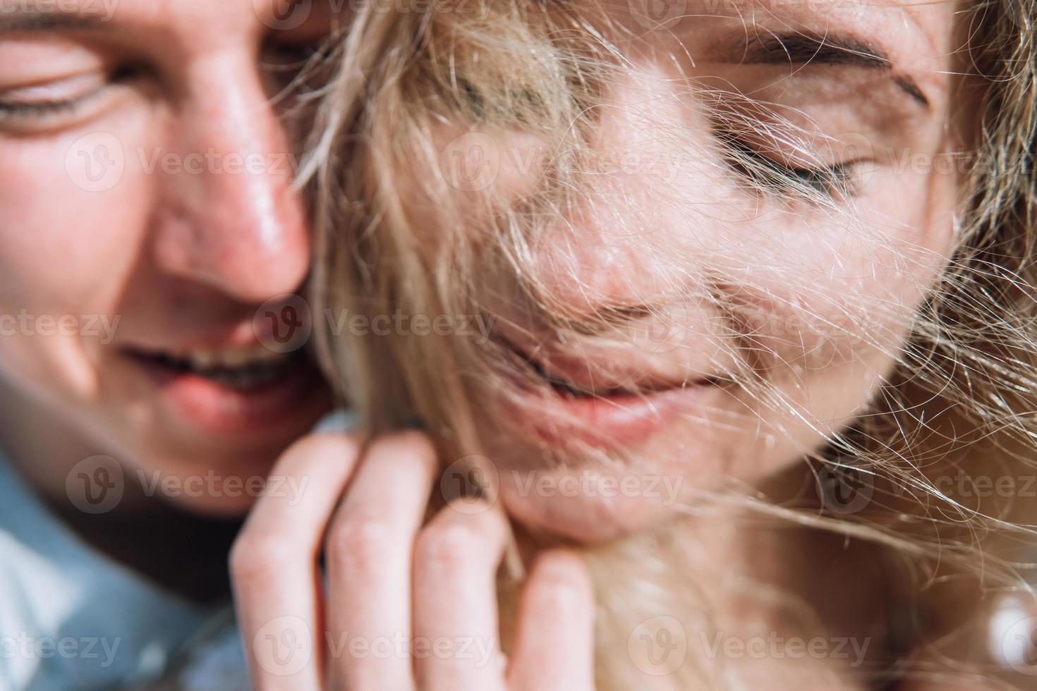 Close-up of guy hugging her girlfriend photo