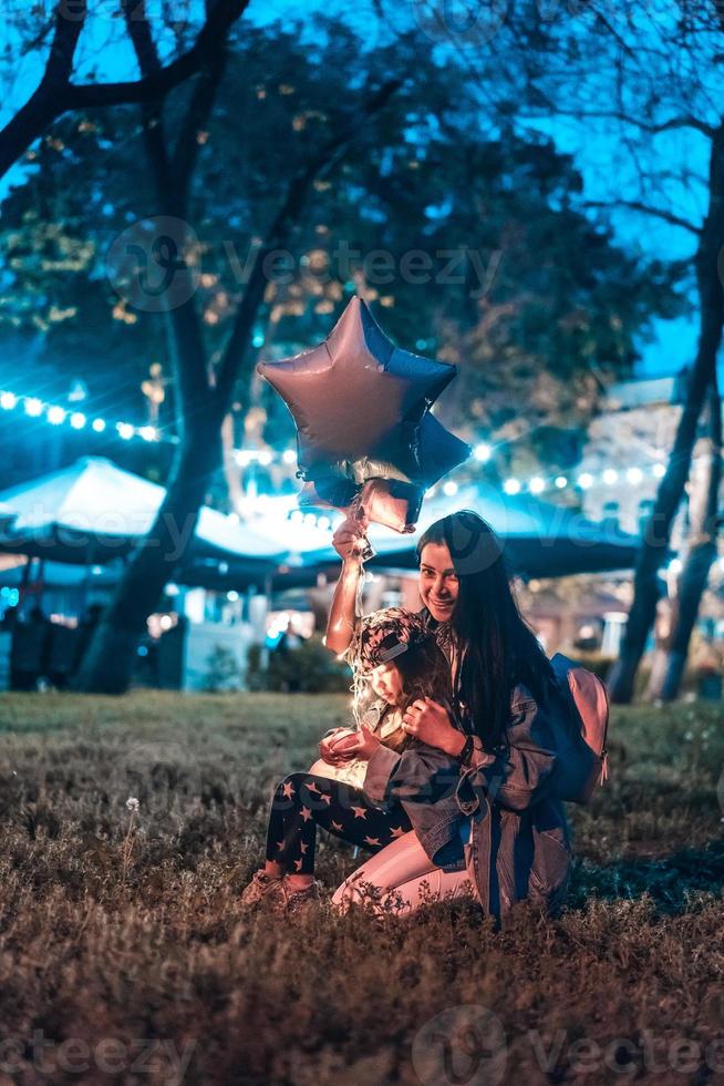 Family is spending time in the evening park photo