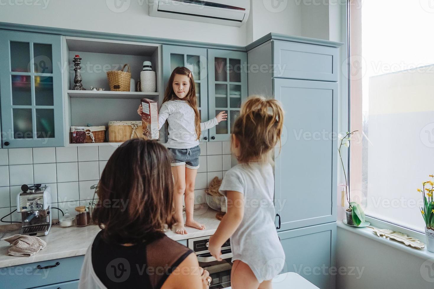 Happy family having fun in the kitchen photo