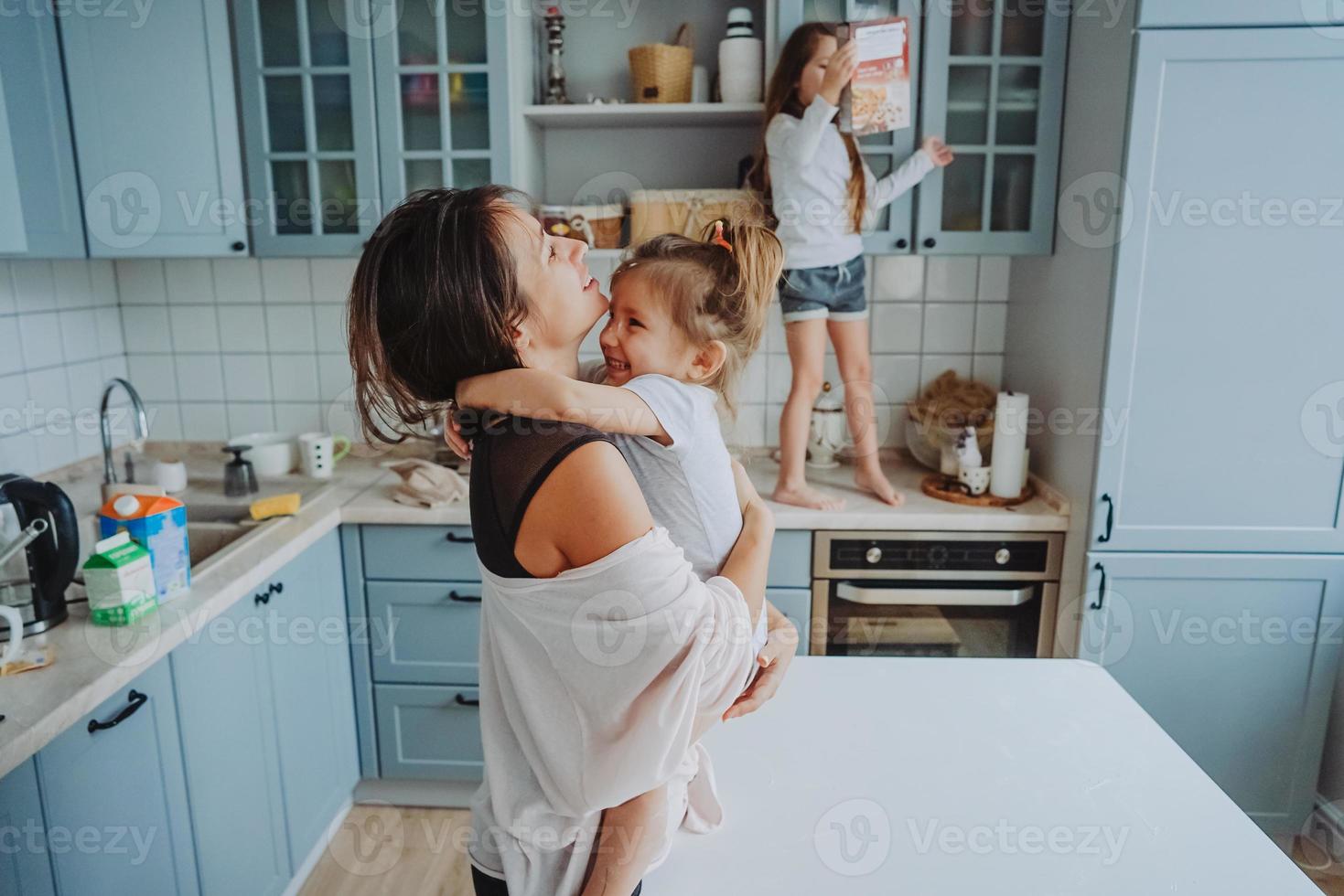 Happy family having fun in the kitchen photo