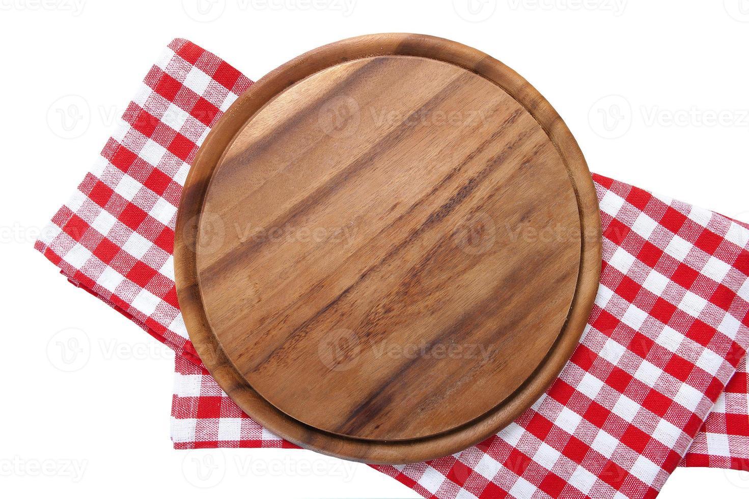 Frame of round cutting board and red plaid tablecloth. Blue wooden background in the cafe. Top view. Macro photo