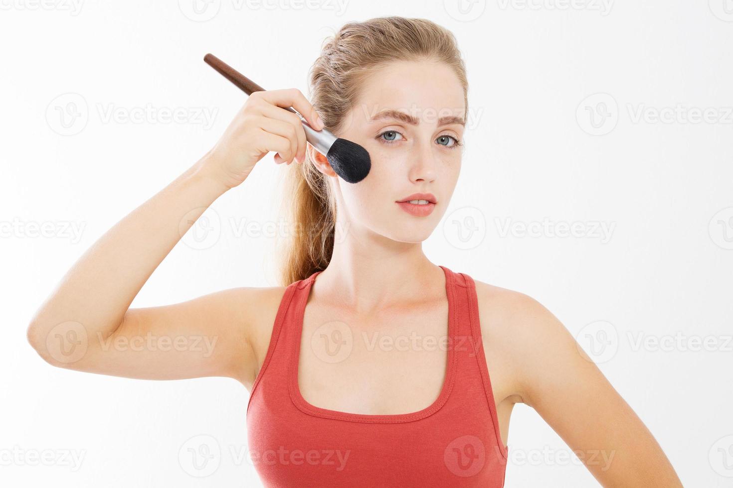 Closeup of happy young woman face with make up brush isolated on white background. Beauty girl skin care concept. Copy space photo