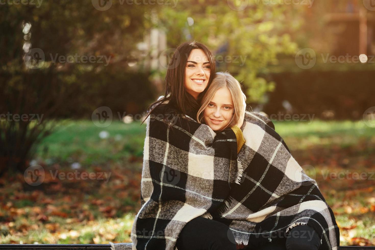 two beautiful in the park, posing for the camera photo