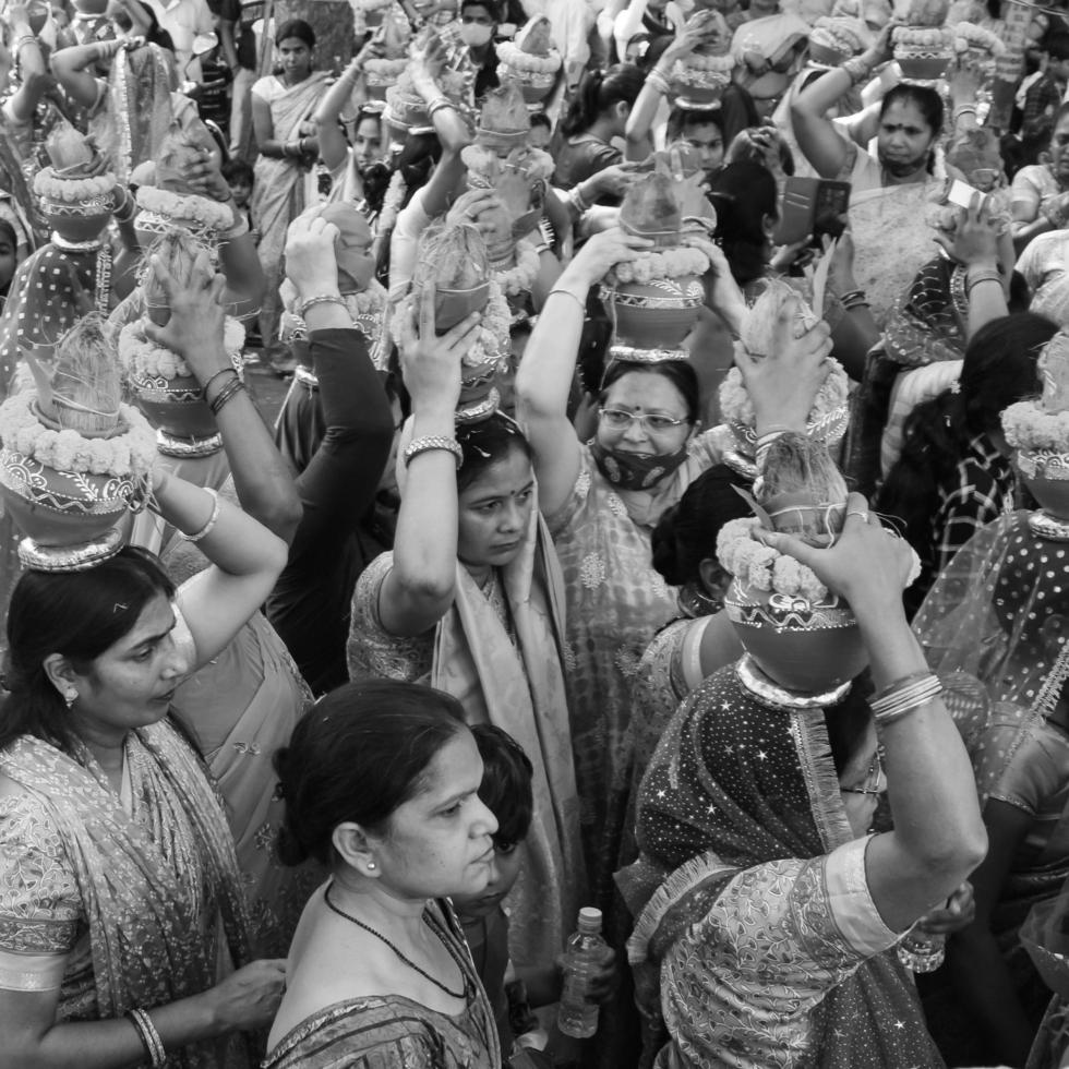 Delhi, India April 03 2022 - Women with Kalash on head during Jagannath Temple Mangal Kalash Yatra, Indian Hindu devotees carry earthen pots containing sacred water with coconut on top-Black and White photo