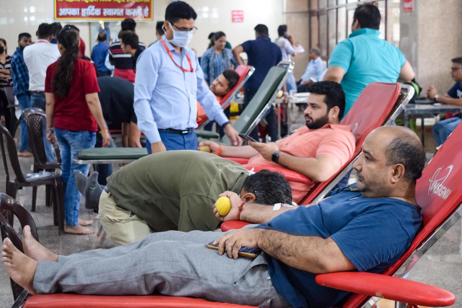 Delhi, India, June 19 2022 - Blood donor at Blood donation camp held at Balaji Temple, Vivek Vihar, Delhi, India, Image for World blood donor day on June 14 every year, Blood Donation Camp at Temple photo