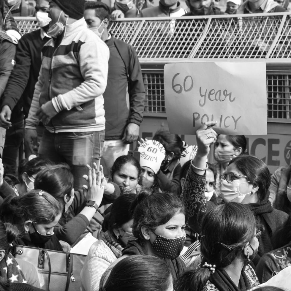 Delhi, India December 25 2021 - Delhi Contractual Guest Teachers with posters, flags and graffitis protesting against Delhi AAP Government for making policy, Delhi Teacher protesting Black and White photo
