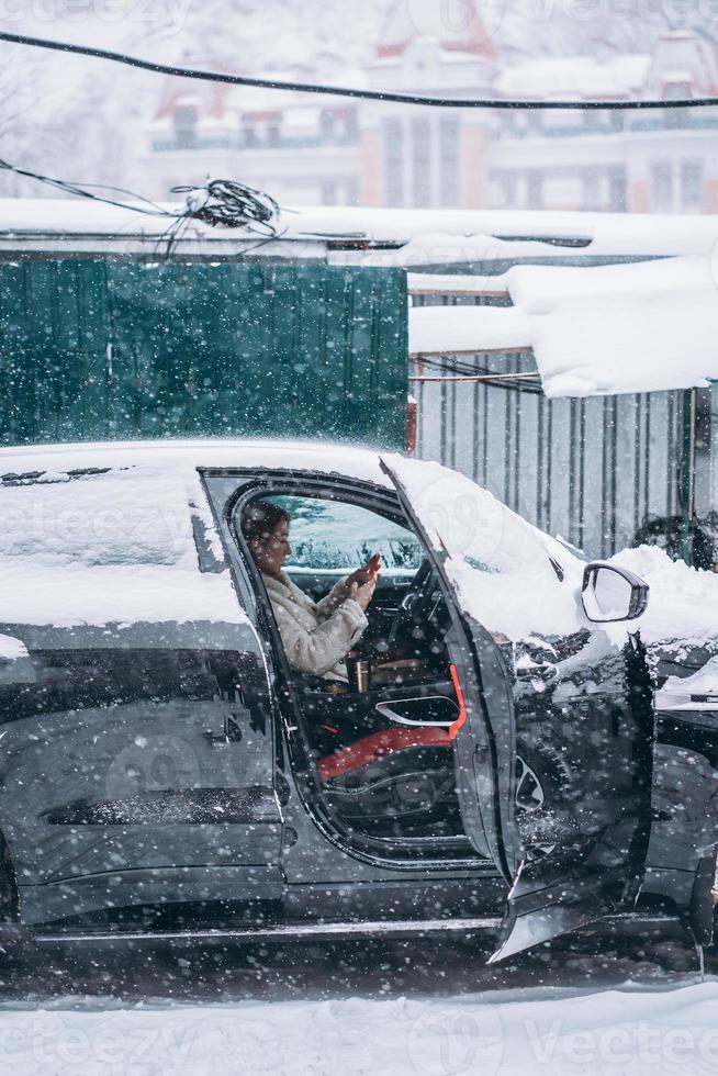 Attractive woman driver nsitting behind the steering wheel in her car photo