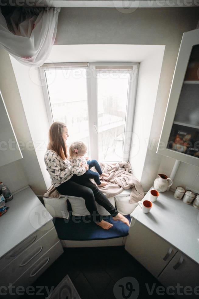 Mother and her daughter girl play in kids room photo