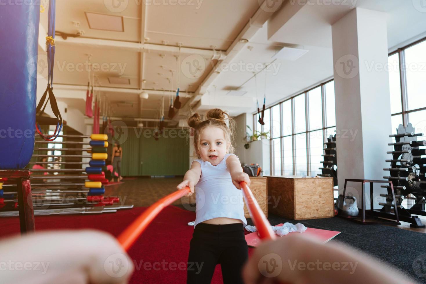 Little girl and mom doing exercises with sticks photo