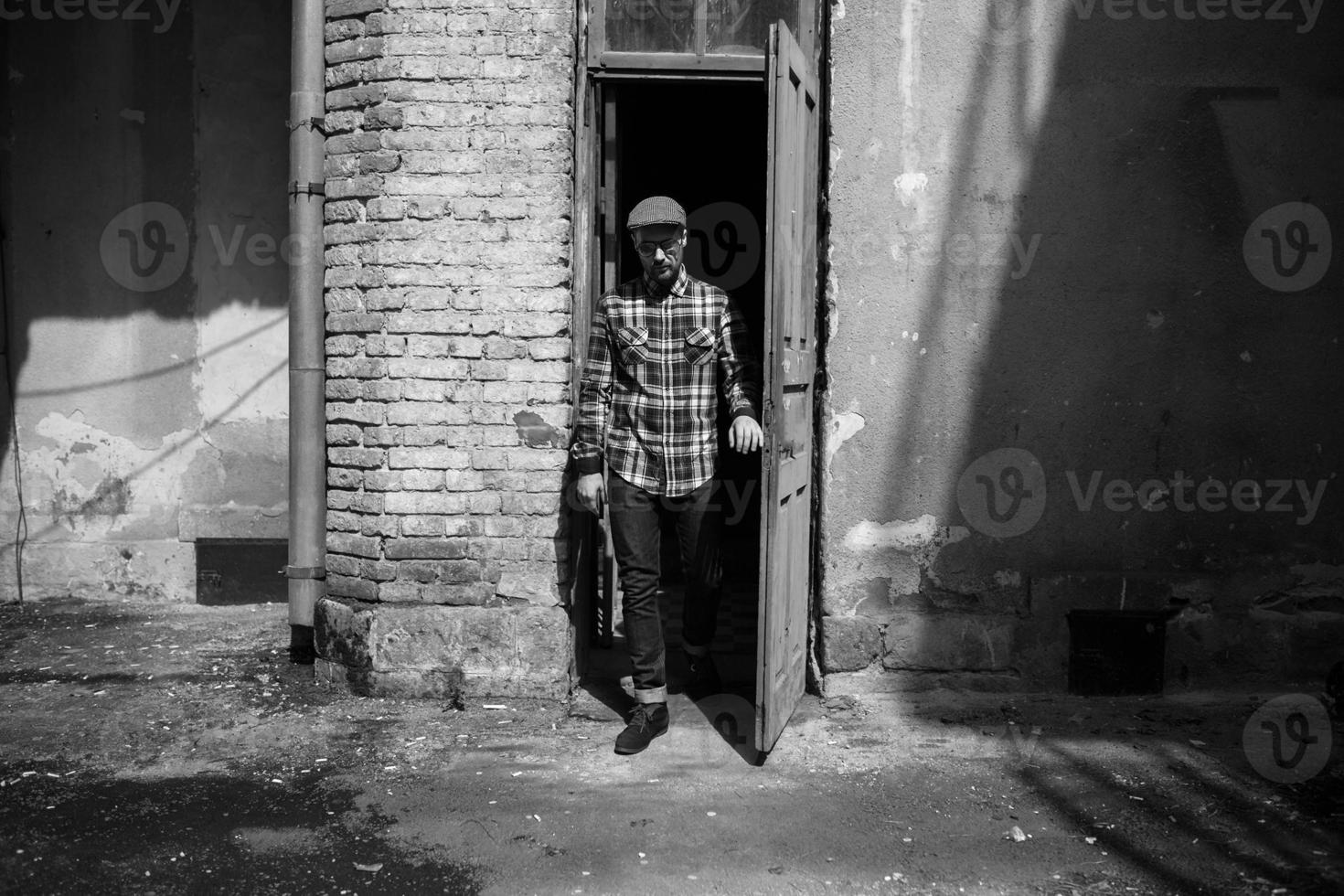 The man in the authentic boots and selvedge jeans  on a background of old city photo