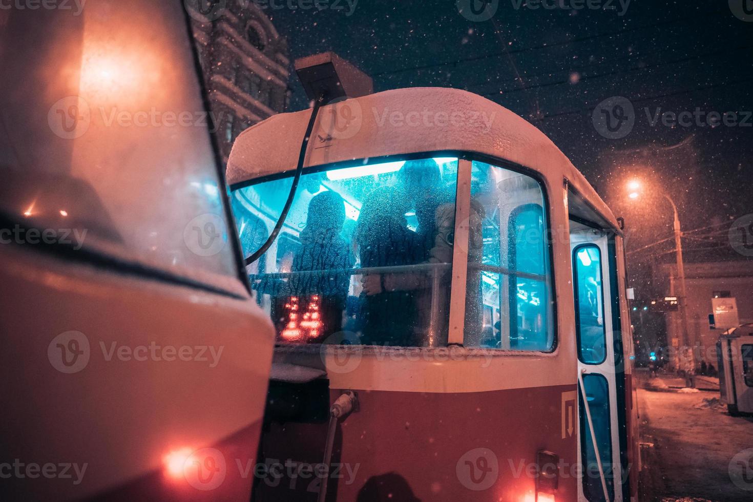 The guy and the girl kiss on the tram behind the misted glass photo