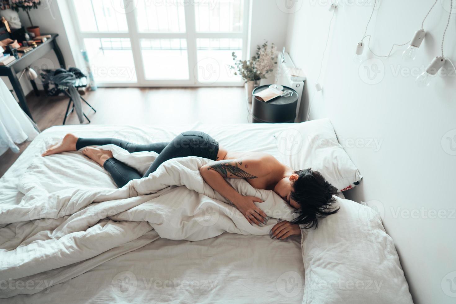 bare girl posing on the bed photo