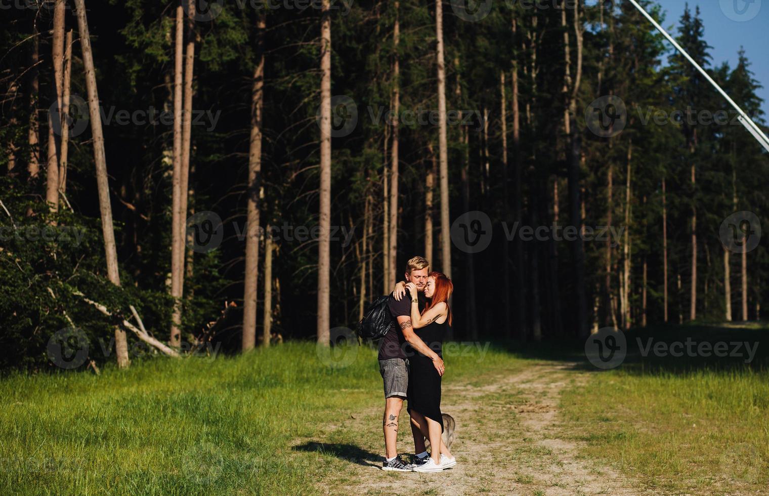 beautiful couple standing in a forest photo