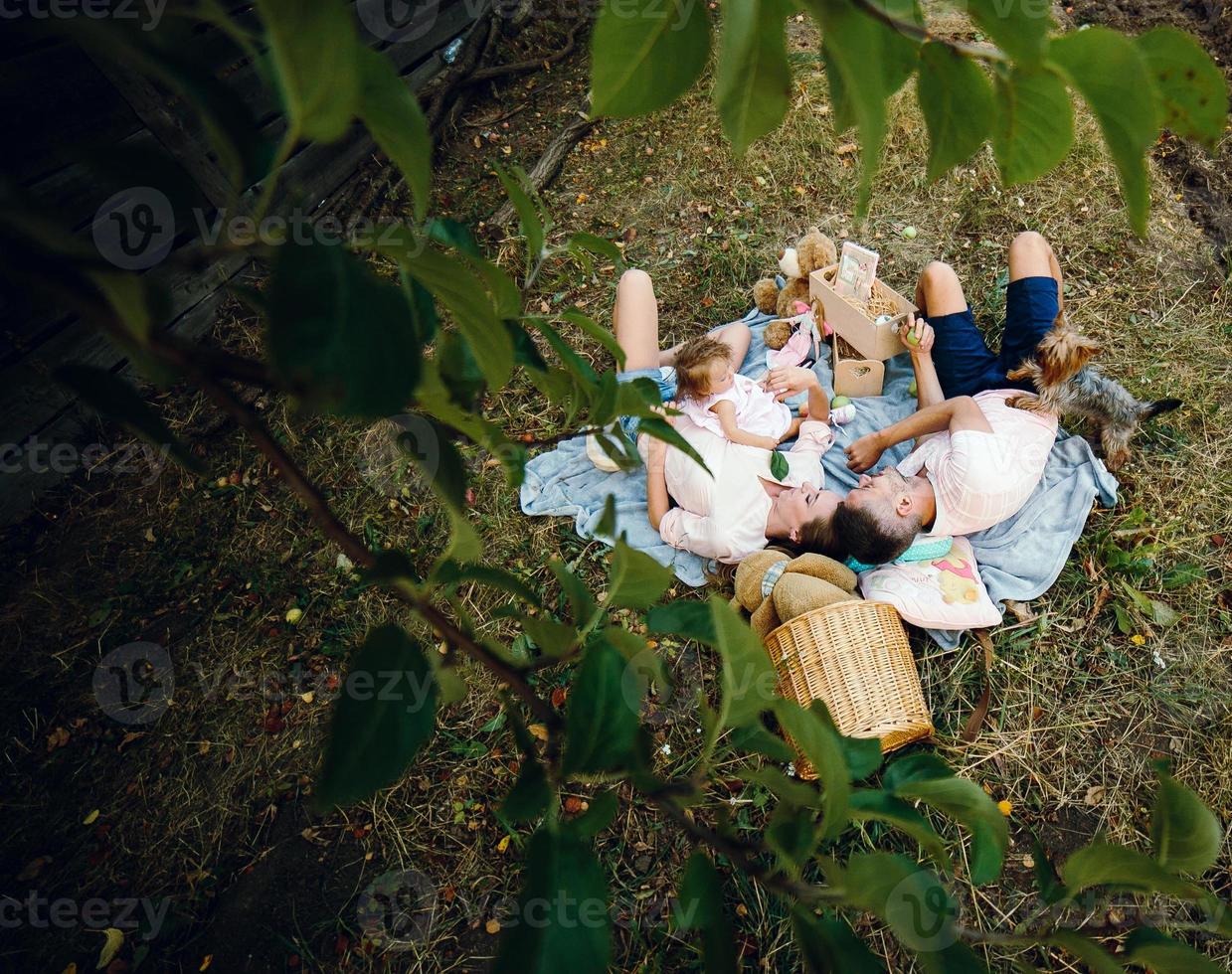 Happy family on lawn in the park photo