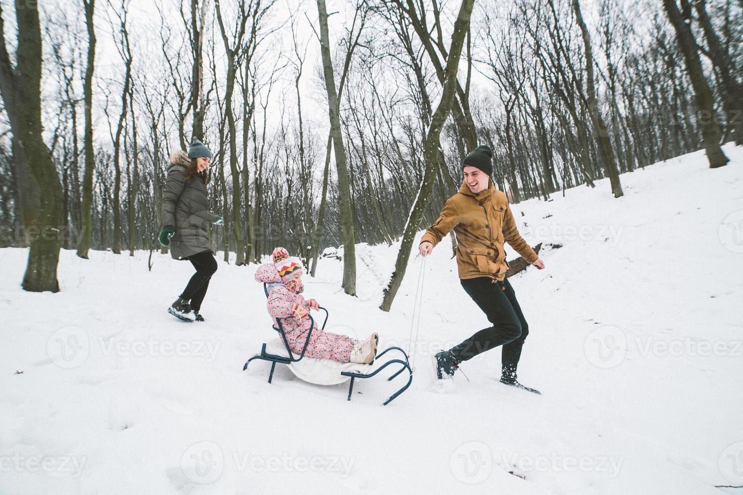 Dad and Mom with a little daughter in the park photo