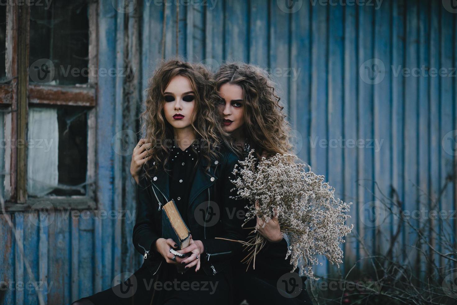 Two vintage witches gathered eve of Halloween photo