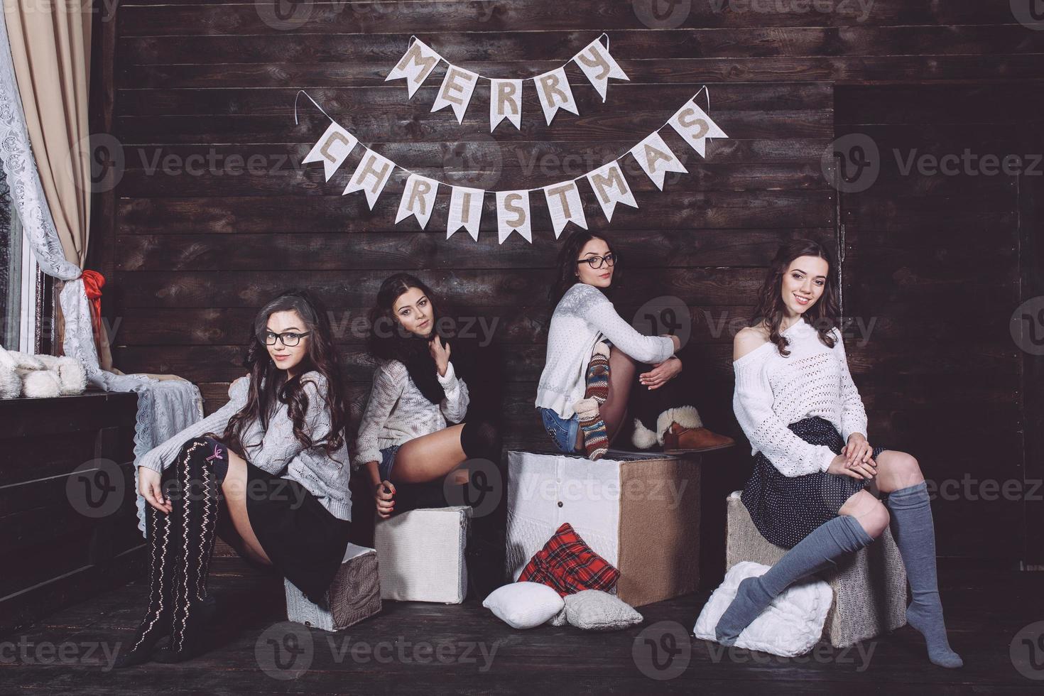 Four charming model posing on a vintage New Year's background photo