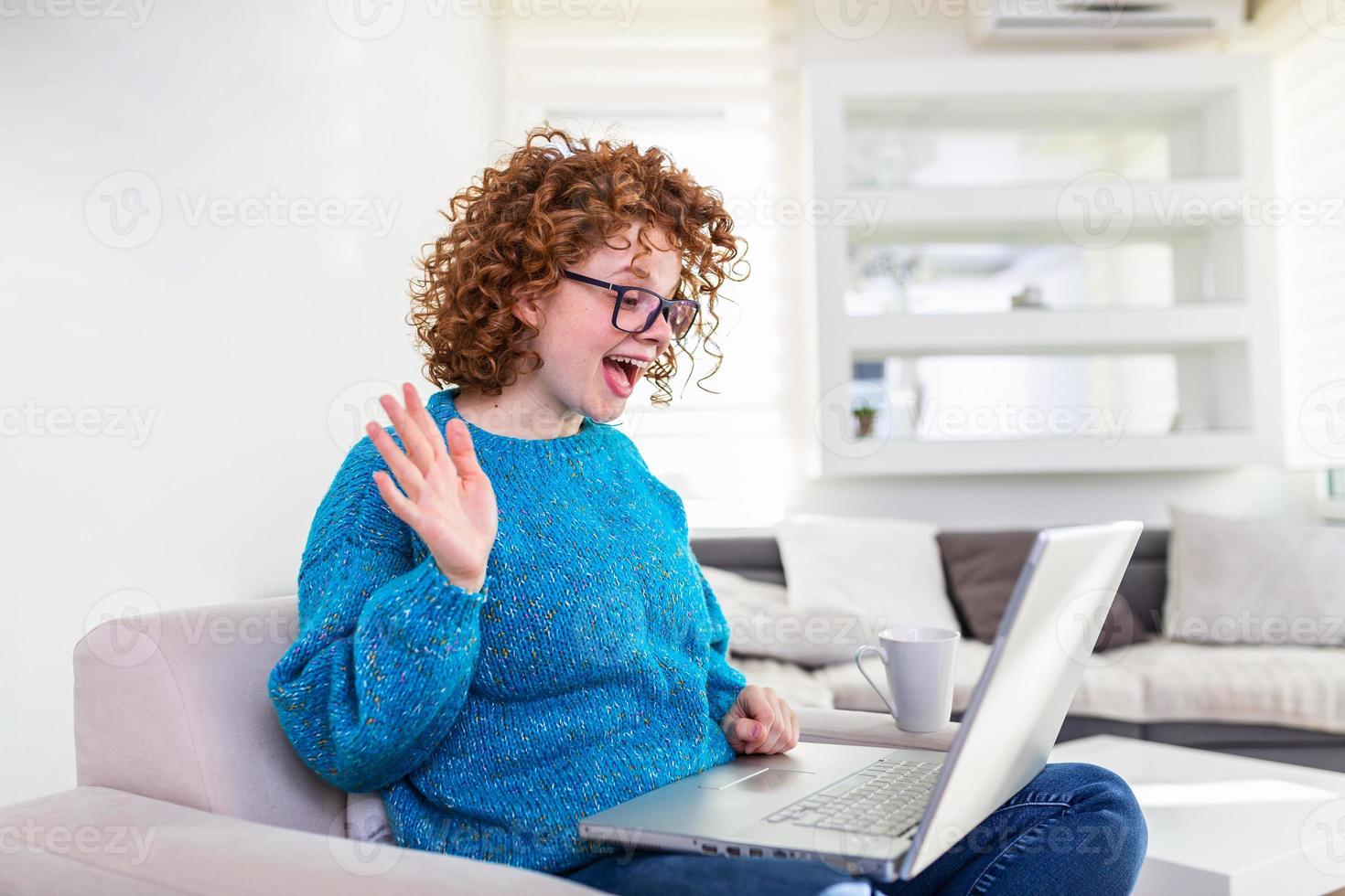 Shot of a businesswoman on a video call while sitting at her desk.Cropped shot of an attractive young woman using her laptop to make a video call at home photo