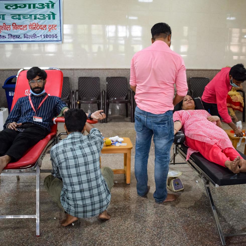 Delhi, India, June 19 2022 - Blood donor at Blood donation camp held at Balaji Temple, Vivek Vihar, Delhi, India, Image for World blood donor day on June 14 every year, Blood Donation Camp at Temple photo