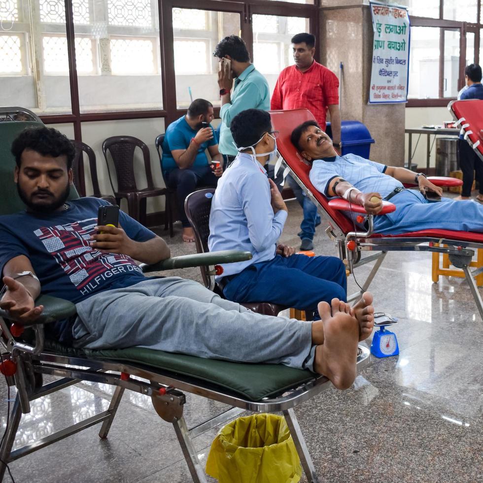 Delhi, India, June 19 2022 - Blood donor at Blood donation camp held at Balaji Temple, Vivek Vihar, Delhi, India, Image for World blood donor day on June 14 every year, Blood Donation Camp at Temple photo